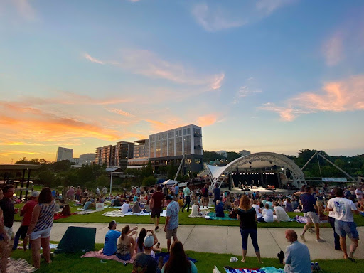 sunset at cascades park, people gathered on the grass