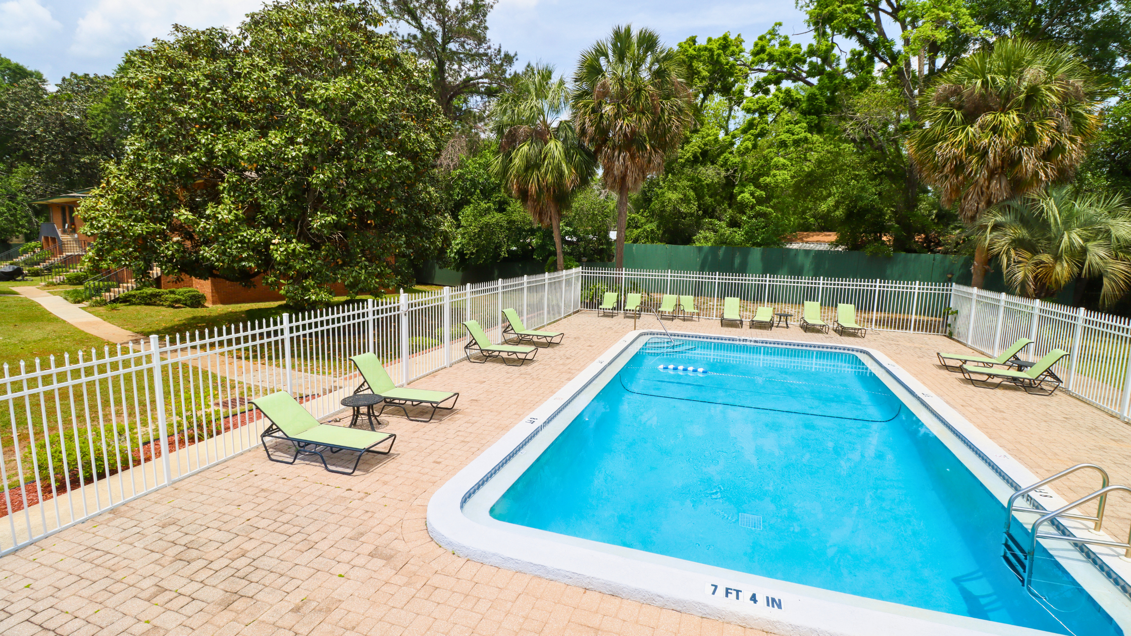 Photo of the clear-blue pool at the Greenbriar Garden Homes apartment complex